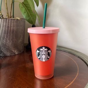 Grande pink and orange Starbucks cup